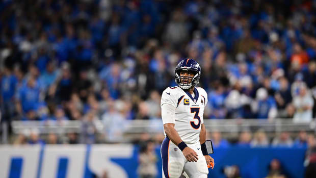 Denver Broncos quarterback Russell Wilson walks off the field during the first half of an NFL football game against the Detroit Lions.