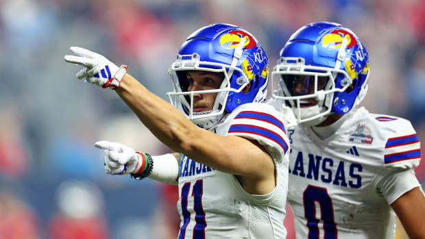 Dec 26, 2023; Phoenix, AZ, USA; Kansas Jayhawks wide receiver Luke Grimm (11) Celebes with wide receiver Quentin Skinner (0) during the second half against the UNLV Rebels in the Guaranteed Rate Bowl at Chase Field. 