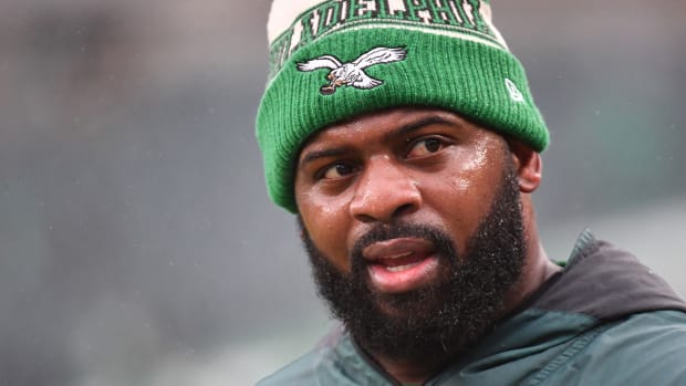 A tight shot of Fletcher Cox’s face, as he wears an kelly green Eagles beanie.