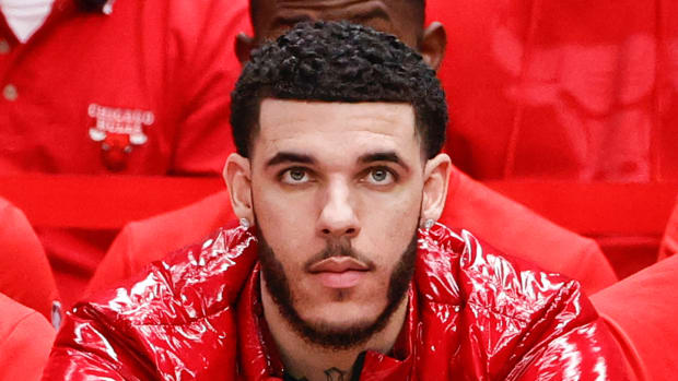 Bulls guard Lonzo Ball sits on the sidelines during a game.