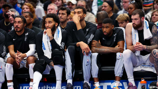 Dec 23, 2023; Dallas, Texas, USA; San Antonio Spurs center Victor Wembanyama (1) sits on the bench with teammates during the second quarter against the Dallas Mavericks at American Airlines Center.