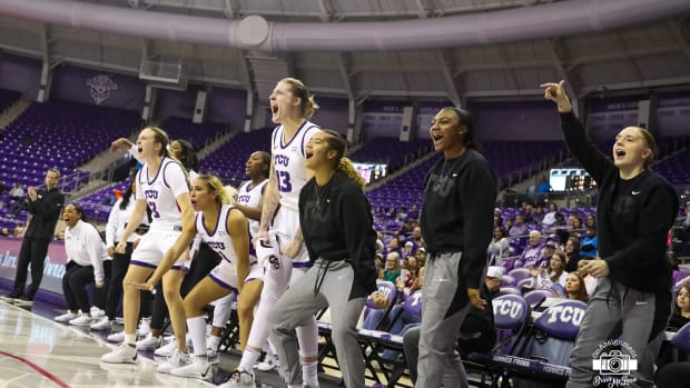 TCU's bench, including starters (left to right) Madison Conner (3), Jaden Owens (1) and Sedona Prince (13), celebrates a made shot against Omaha.
