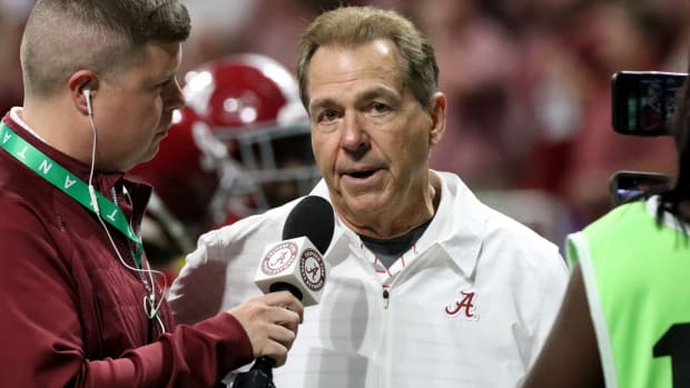 Alabama Crimson Tide head coach Nick Saban talks with a reporter at halftime of the SEC championship game against Georgia.
