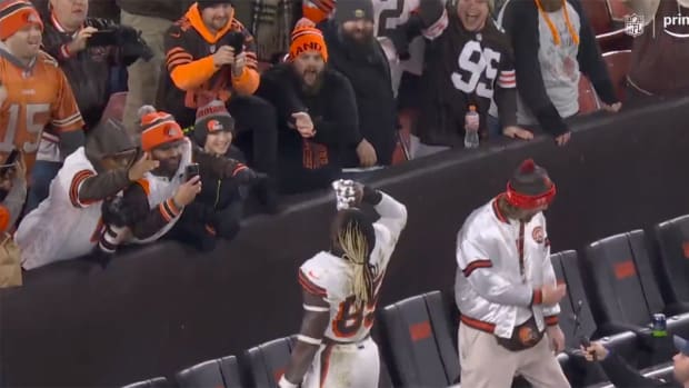 Cleveland Browns tight end David Njoku celebrates with fans after clinching playoff berth.
