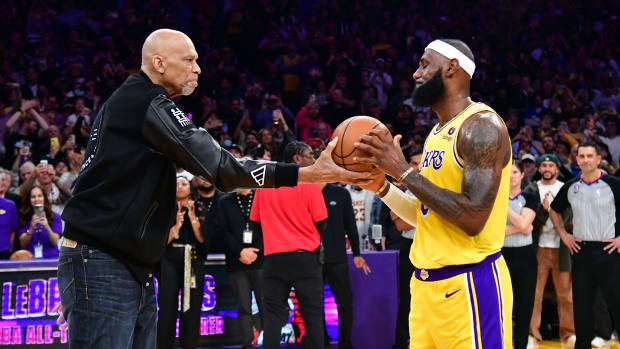 Los Angeles Lakers forward LeBron James (6) takes a ball from Kareem Abdul-Jabbar after breaking the record for all-time scoring in the NBA during the third quarter against the Oklahoma City Thunder at Crypto.com Arena on Feb. 7, 2023.