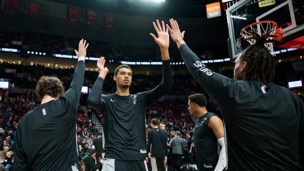 Dec 28, 2023; Portland, Oregon, USA; San Antonio Spurs center Victor Wembanyama (1) high-fives teammates during introductions before a game against the Portland Trail Blazers at Moda Center.