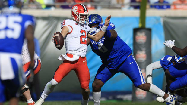 Kentucky Wildcats defensive lineman Deone Walker (0) sacks Clemson Tigers quarterback Cade Klubnik (2) during the second quarter of an NCAA football matchup in the TaxSlayer Gator Bowl Friday, Dec. 29, 2023 at EverBank Stadium in Jacksonville, Fla. [Corey Perrine/Florida Times-Union]