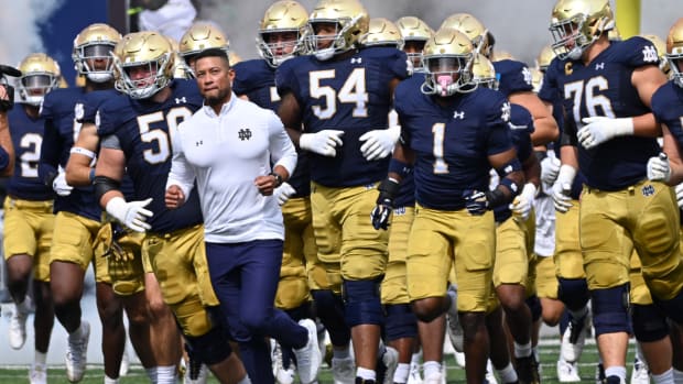 Sep 16, 2023; South Bend, Indiana, USA; Notre Dame Fighting Irish head coach Marcus Freeman leads his players onto the field for the game against the Central Michigan Chippewas at Notre Dame Stadium.