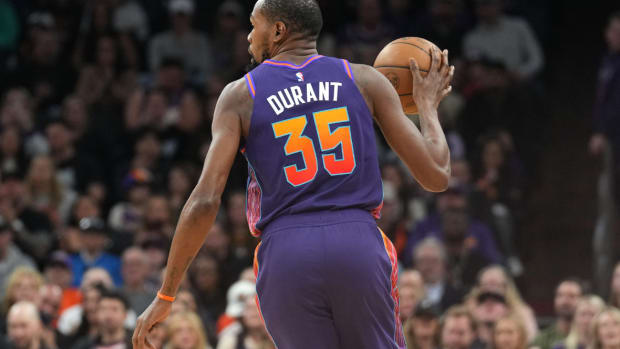 Phoenix Suns forward Kevin Durant (35) dribbles against the Charlotte Hornets during the first half at Footprint Center.