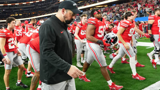 Ohio State coach Ryan Day and Buckeyes players exit the field at AT&T Stadium after their Cotton Bowl loss to Missouri on Dec. 29, 2023.