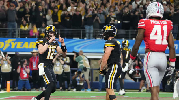 Missouri Tigers quarterback Brady Cook (12) pretends to take a photo of running back Cody Schrader (7) after he scored a touchdown during the third quarter of the Goodyear Cotton Bowl Classic against the Ohio State Buckeyes at AT&T Stadium.