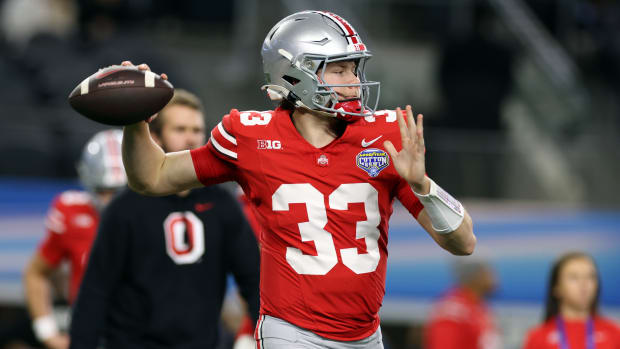 Dec 29, 2023; Arlington, TX, USA; Ohio State Buckeyes quarterback Devin Brown (33) throws a pass before the game against the Missouri Tigers at AT&T Stadium.