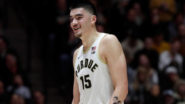 Purdue center Zach Edey smiles while playing in a game.