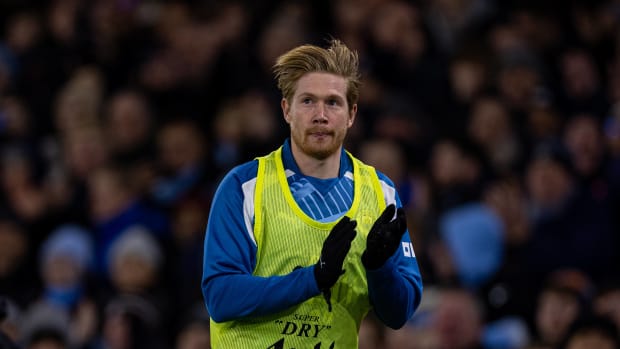 Kevin De Bruyne pictured applauding Manchester City supporters while warming up during a Premier League game against Sheffield United in December 2023