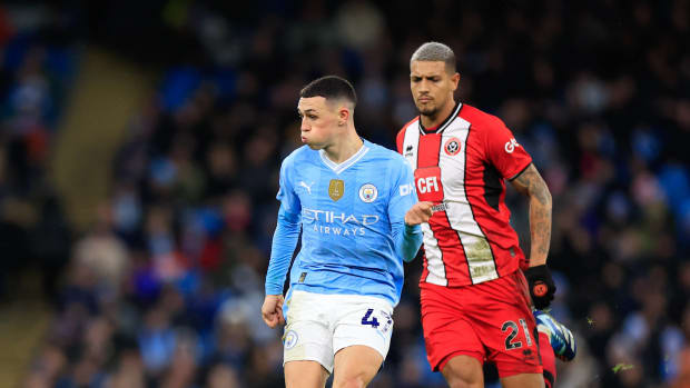 Phil Foden pictured (center) passing the ball during Manchester City's 2-0 win over Sheffield United in December 2023