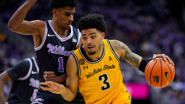 Dec 21, 2023; Kansas City, Missouri, USA; Wichita State Shockers forward Ronnie DeGray III (3) drives against Kansas State Wildcats forward David N'Guessan (1) during the second half at T-Mobile Center. Mandatory Credit: Jay Biggerstaff-USA TODAY Sports  