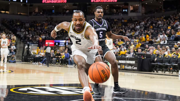 Missouri Tigers guard Tamar Bates (2) chases after a loose ball as Central Arkansas Bears guard Masai Olowokere (5) looks on during the first half at Mizzou Arena.