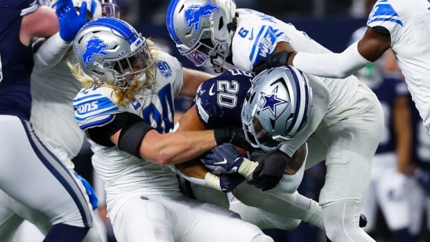 Dec 30, 2023; Arlington, Texas, USA; Dallas Cowboys running back Tony Pollard (20) is tackled by Detroit Lions linebacker Alex Anzalone (34) and Detroit Lions safety Ifeatu Melifonwu (6) during the second half at AT&T Stadium.