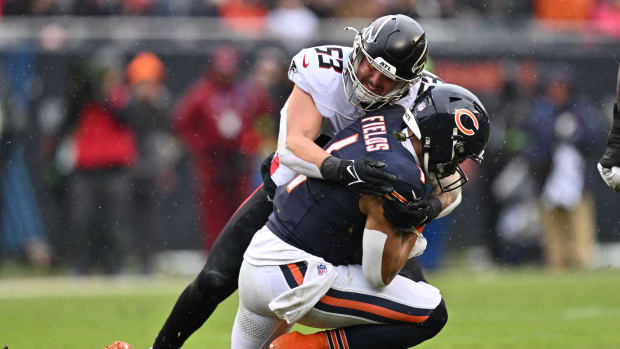 Dec 31, 2023; Chicago, Illinois, USA; Chicago Bears quarterback Justin Fields (1) is tackled by Atlanta Falcons linebacker Nate Landman (53) after a short gain in the first half at Soldier Field.