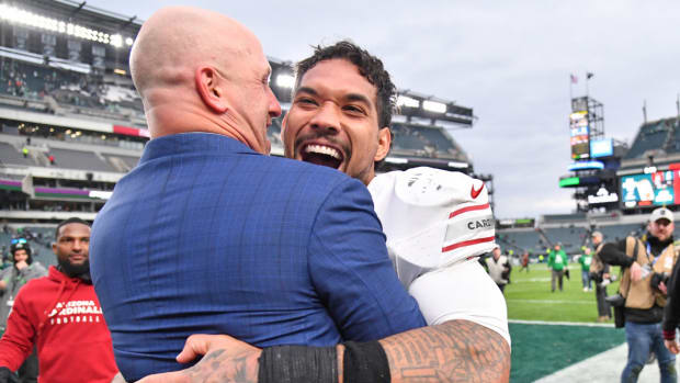 Arizona Cardinals general manager Monti Ossenfort hugs running back James Conner (6) after win against the Philadelphia Eagles at Lincoln Financial Field.