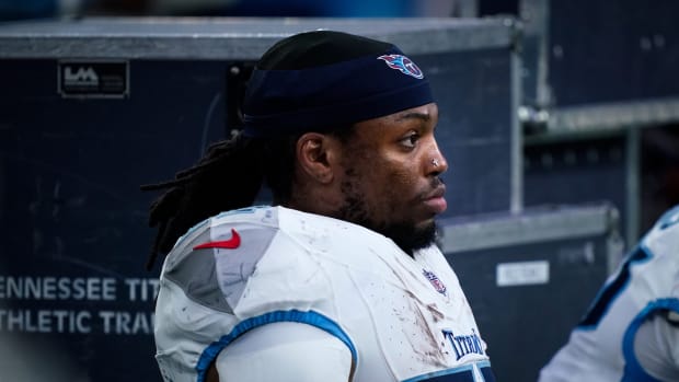 Tennessee Titans running back Derrick Henry (22) sits on the sideline late during the fourth quarter of their loss to the Houston Texans at NRG Stadium in Houston on Sunday.