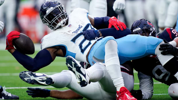 Tennessee Titans running back Derrick Henry (22) is stopped by the Houston Texans defense during the fourth quarter at NRG Stadium in Houston on Sunday.