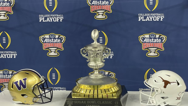 The Sugar Bowl trophy is surrounded by Husky and Longhorn helmets.
