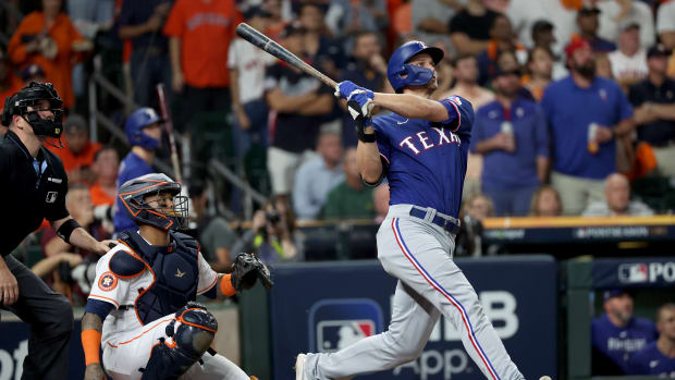 Texas Rangers shortstop Corey Seager hits a home run during the first inning of Game 7 of the ALCS against the Houston Astros at Minute Maid Park.