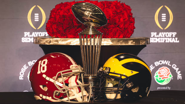 Alabama and Michigan helmets with Rose Bowl trophy