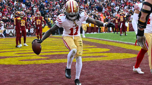 Dec 31, 2023; Landover, Maryland, USA; San Francisco 49ers wide receiver Brandon Aiyuk (11) celebrates after scoring a touchdown against the Washington Commanders during the second half at FedExField. Mandatory Credit: Brad Mills-USA TODAY Sports  