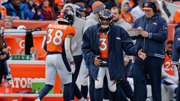 Denver Broncos quarterback Russell Wilson (3) reacts with running back Jaleel McLaughlin (38) after a play in the second quarter against the Los Angeles Chargers at Empower Field at Mile High.