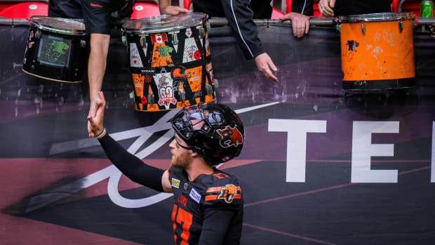 Jun 17, 2023; Vancouver, British Columbia, CAN; A BC Lions fan gives BC Lions quarterback Dane Evans (17) a high five after the game against the Edmonton Elks at BC Place. BC won 22-0. Mandatory Credit: Bob Frid-USA TODAY Sports  