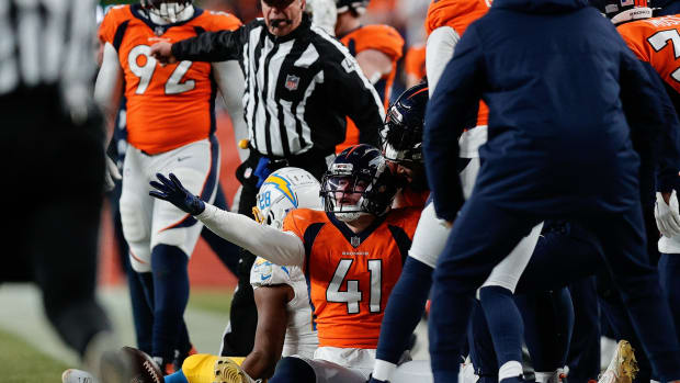 Denver Broncos linebacker Drew Sanders (41) reacts after a play with Denver Broncos cornerback Art Green (28) in the fourth quarter at Empower Field at Mile High.