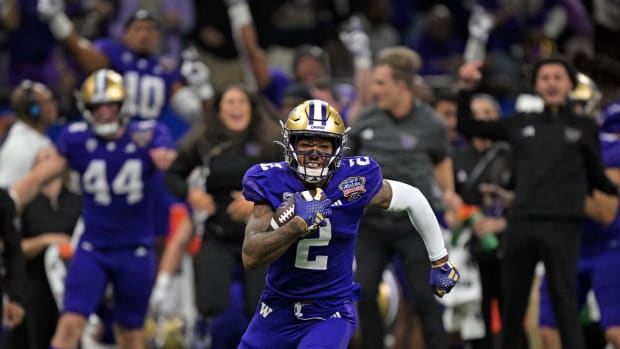 Washington Huskies wide receiver Ja'Lynn Polk (2) runs with the ball after a catch against the Texas Longhorns during the first quarter in the 2024 Sugar Bowl college football playoff semifinal game at Caesars Superdome.