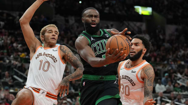 Dec 31, 2023; San Antonio, Texas, USA; Boston Celtics guard Jaylen Brown (7) loses the ball in front of San Antonio Spurs forwards Jeremy Sochan (10) Julian Champagnie (30) in the first half at Frost Bank Center.