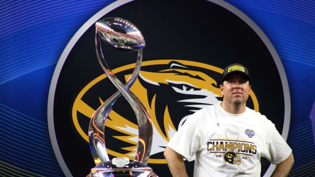 Dec 29, 2023; Arlington Texas, USA; Missouri Tigers coach Eli Drinkwitz looks out at the gathered crowd at AT&T Stadium next to the Field Scovell Trophy as his team is announced the winner of the 88th Annual Goodyear Cotton Bowl Classic.