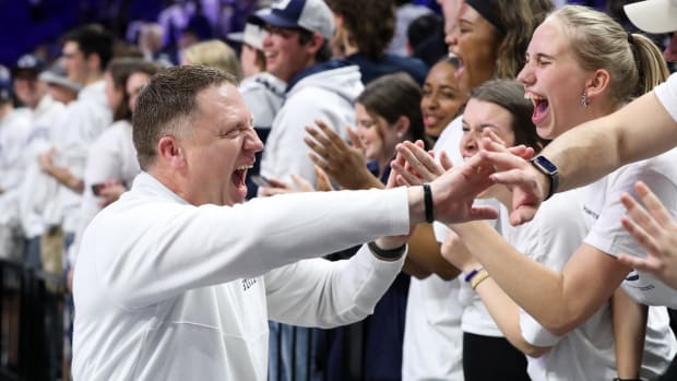 Penn State coach Mike Rhoades celebrates with fans after the Nittany Lions' win over Ohio State at the Bryce Jordan Center.