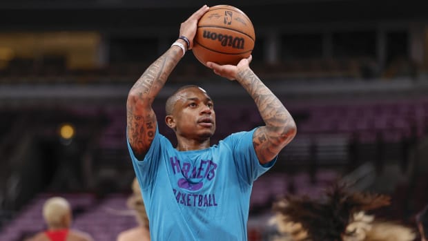 Charlotte Hornets point guard Isaiah Thomas shoots a ball in warmups before a game.