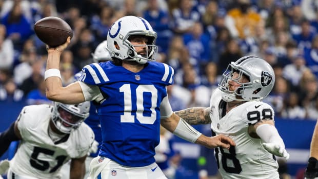 Dec 31, 2023; Indianapolis, Indiana, USA; Indianapolis Colts quarterback Gardner Minshew (10) passes the ball while Las Vegas Raiders defensive end Maxx Crosby (98) defends in the first half at Lucas Oil Stadium. Mandatory Credit: Trevor Ruszkowski-USA TODAY Sports