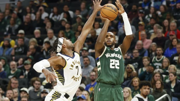 Milwaukee Bucks forward Khris Middleton (22) shoots against Indiana Pacers guard Buddy Hield (7)