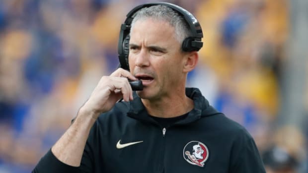 Florida State Seminoles head coach Mike Norvell calls a play on the sideline during a college football game.