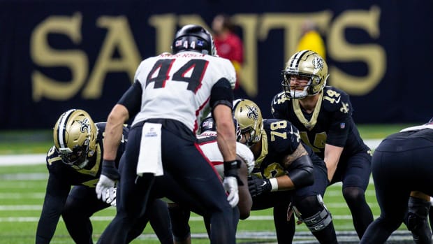 Dec 18, 2022; New Orleans, Louisiana, USA; New Orleans Saints quarterback Andy Dalton (14) goes against Atlanta Falcons linebacker Troy Andersen (44) during the second half at Caesars Superdome.