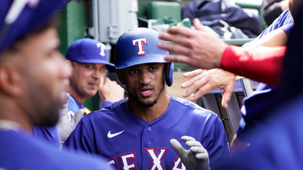 Apr 9, 2023; Chicago, Illinois, USA; Texas Rangers center fielder Bubba Thompson (8) is greeted in the dugout after scoring against the Chicago Cubs during the sixth inning at Wrigley Field.