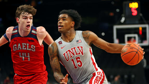 Dec 16, 2023; Phoenix, Arizona, USA; UNLV Rebels guard Luis Rodriguez (15) drives to the basket against St. Mary's Gaels guard Alex Ducas (44) during overtime at Footprint Center. 