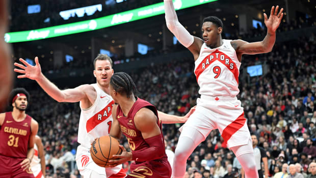 Jan 1, 2024; Toronto, Ontario, CAN; Toronto Raptors center Jakob Poeltl (19) and forward RJ Barrett (9) defend their basket as Cleveland Cavaliers guard Isaac Okoro (35) looks to make a pass in the first half at Scotiabank Arena.