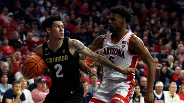 Colorado Buffaloes guard KJ Simpson (2) gets a rebound against Arizona Wildcats guard KJ Lewis (5) during the second half at McKale Center