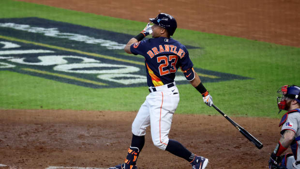 Oct 16, 2023; Houston, Texas, USA; Houston Astros designated hitter Michael Brantley (23) hits an RBI double in the sixth inning against the Texas Rangers during game two of the ALCS for the 2023 MLB playoffs at Minute Maid Park.