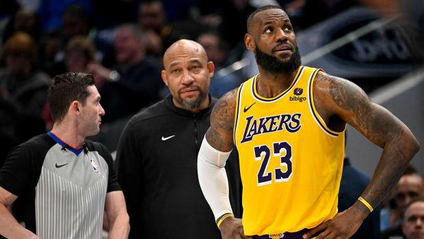 Darvin Ham, LeBron James look on from the Lakers bench.