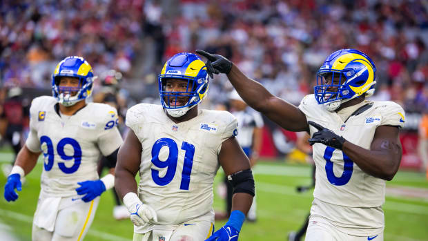 Nov 26, 2023; Glendale, Arizona, USA; Los Angeles Rams defensive tackle Kobie Turner (91) with linebacker Byron Young (0) and defensive tackle Aaron Donald (99) against the Arizona Cardinals at State Farm Stadium.