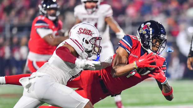 Dec 1, 2023; Lynchburg, VA, USA; Liberty Flames wide receiver CJ Daniels (4) catches a pass against the New Mexico State Aggies during the first quarter at Williams Stadium. Mandatory Credit: Brian Bishop-USA TODAY Sports  